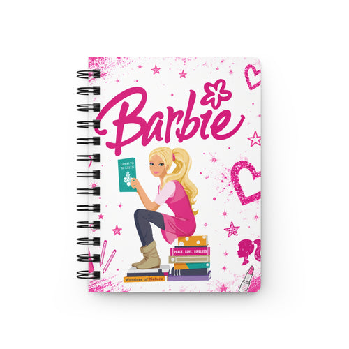 Pink spiral notebook with Barbie graphics and girl reading a book on the cover